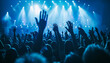 © Oleksiy - Large group of happy people enjoying rock concert, clapping with raised up hands, blue lights from the stage