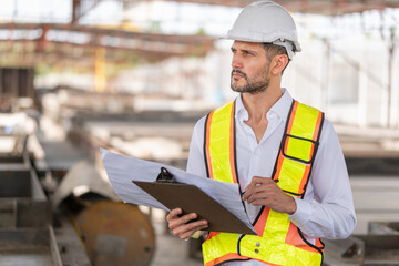 Wall Mural - Engineer man working at construction site, Foreman worker planning project in the factory site