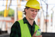 © Poguz.P - Man drinking water at the precast factory site, Engineer man drinking water at construction site.