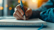 © MP-AI - Close-up of a person's hand writing in a notebook with a pen, sunlight in the background, ideal for education and creativity concepts.