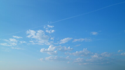 Blue sky with copyspace background with forming clouds in summer day outdoors. Timelapse.