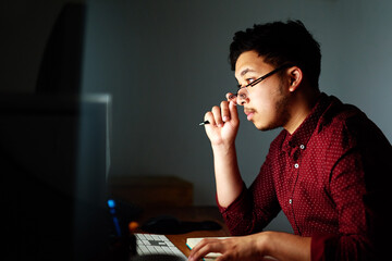 Poster - Man, thinking and computer at night in office with notebook, coding information or software programming. Geek developer, pc and notes with glasses for database update, it report and server deadline
