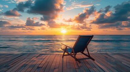 Blue beach chair on a wooden deck terrace overlooking a sunset sea view and cloudy seascape for wallpaper background vacation and holiday concept