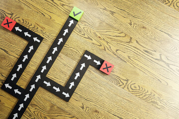 Aufkleber - Arrows on a path with X and check marks on wooden background, depicting concept of decision making in business. 3D Rendering