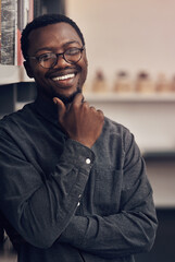 Poster - Smile, pride and portrait of architect in office with information books by shelf at startup company. Happy, confident and black man with career in architecture working on industrial design project.