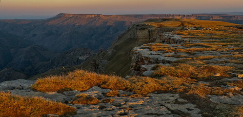 Wall Mural - Russia, the Elbrus region. The first touch of sunlight on the top of the rocks of the Bolshoy Bermamyt plateau in the early morning near Mount Elbrus.