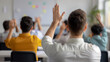 © aciddreamStudio - rear view of students in class raising hands