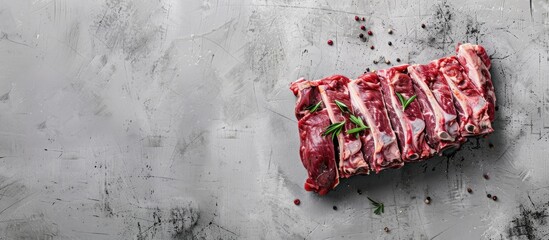 Wall Mural - Fresh lamb or mutton meat on a gray background, photographed from above with room for text.