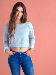 Wall Mural - Studio, portrait and woman with fashion, beauty and natural confidence on pink background. College student, model and attitude in Gen z clothing for trendy style, edgy chic and hands in pockets