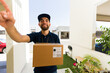 © AntonioDiaz - Courier in uniform rings a doorbell with a package, providing reliable delivery service and a smooth shopping experience