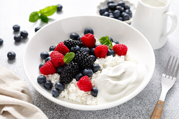 Wall Mural - Cheese cottage with yogurt and fresh berries. Curd with blueberry, raspberry and blackberry