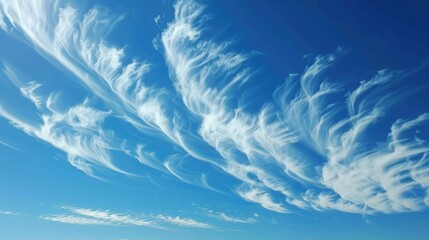 Wall Mural - White clouds against a stunningly clear deep blue sky on a sunny day