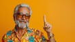 © TraditionalModeling - Portrait Senior Man With Beard Pointing Up, Yellow Background