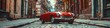 Urban Street Scene: Photograph a retro car parked on a cobblestone street in a historic city neighborhood, surrounded by old-fashioned street lamps and architecture