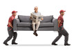 © Ljupco Smokovski - Elderly man reading a newspaper and sitting on a sofa carried by two movers