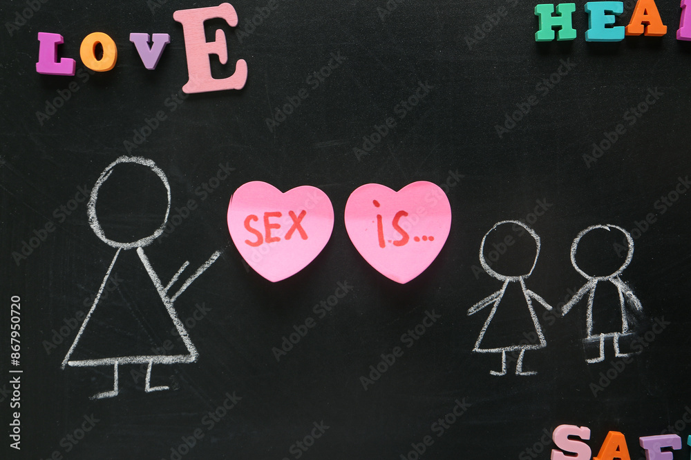 Chalkboard with drawn figures of teacher and children. Sex education
