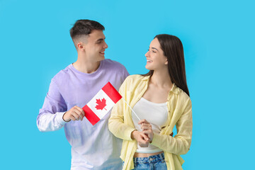 Canvas Print - Young couple with flag of Canada on blue background