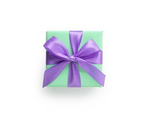 Wall Mural - Top view of green gift box with purple ribbon bow isolated on white background