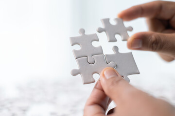 Team with piece of jigsaw puzzle as critical component of business strategy, understanding teamwork and collaboration were essential for achieving success and realizing concept of well-executed plan.