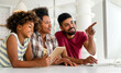 © NDABCREATIVITY - Smiling african american family working with a computer at home. Technology people concept