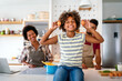 © NDABCREATIVITY - Overjoyed young african american family with kid have fun cooking at home together,