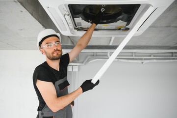 Wall Mural - Happy Male Technician Repairing Air Conditioner