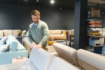 Wall Mural - Man in furniture store choosing sofa