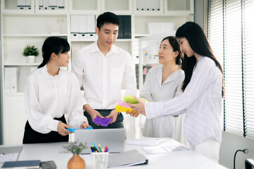 Asian Man and woman co-worker consult about work or team meeting at work with serious emotion.