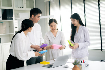 Asian Man and woman co-worker consult about work or team meeting at work with serious emotion.