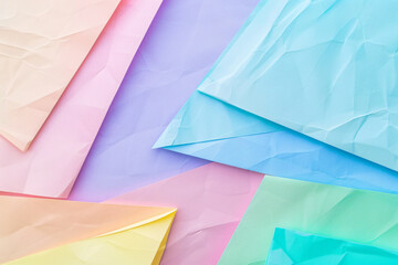 Poster - Soft pastel background with pink, blue, and green gradient featuring a triangular paper shape for copy space in the view from above.


