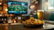 © Mariya - Close-up image of two mugs of beer and chips with TV soccer football match in the blur background. For sports event poster, banner design, website blogs, sportbar decor. International Beer Day. Soccer
