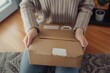 © alisaaa - Woman opening a package One woman, female opening cardboard boxes packages that she just received