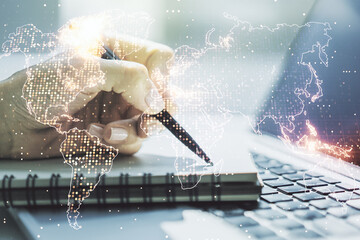 Poster - Abstract creative digital world map and hand writing in diary on background with laptop, globalization concept. Multiexposure