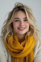 Wall Mural - Radiant Young Woman with Blonde Hair and Mustard Scarf Smiling