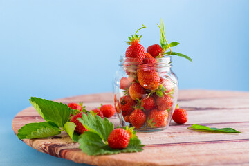 Wall Mural - fresh sweet red strawberries in a glass jar