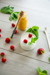 Poster - homemade sweet yogurt in a jar with strawberries, on a wooden table