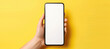 © Gnublin - template of smartphone in hands on yellow background