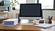 © Basharti - A well-organized office desk with a desktop computer, a stack of documents, and office supplies neatly arranged.