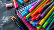 © Blue_Utilities - Colorful markers and notebooks arranged on a dark surface