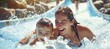 © spyrakot - Mother and Son Enjoying a Fun Day at a Water Park, Splashing Down a Water Slide with Joyful Smiles