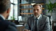 © ngstock - An HR manager conducting a one-on-one retention interview in a sleek office, professional attire, attentive listening, supportive environment