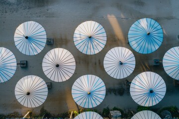 Poster - Aerial Symmetry of Blue and White Striped Umbrellas Geometric Pattern and Textured Background in Natural Light