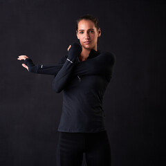 Poster - Woman, portrait and stretching arms in studio for fitness, health or self care on black background. Female athlete, face and warm up for crossfit, wellness and performance goals at sports competition