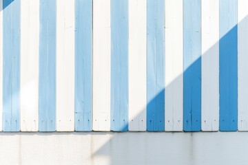 Poster - Bright Blue and White Striped Pattern on Sunny Day Crisp Shadows Creating Depth Against a Simple Background