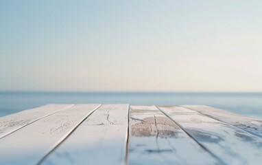 Poster - Serene Summer Coastal Scene with Smooth White Table for Product Display, Bokeh Background with Soft Sunlight and Tranquil Blue Tones