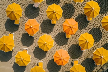 Poster - Symmetrical Aerial View of Orange Beach Umbrellas on Sandy Beach with Intricate Geometric Patterns in Bright Daylight