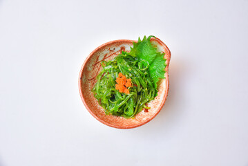 Seaweed salad topped with flying fish eggs ready to eat