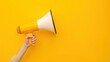 © ParinApril - Hand holding megaphone, marketing and sales, yellow background hand megaphone marketing sale concept orange background communication advertising promotion announcement loudspeaker