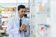 © eakgrungenerd - Portrait male charming smiling pharmacist. man professional medication in drugstore. pharmacist or medical professional or healthcare.