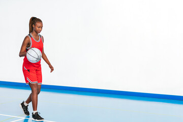 Horizontal photo young female basketball player practicing dribbling. Sport concept.